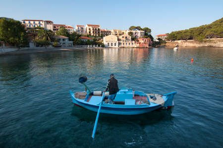 Assos village, Kefalonia with fishing boat in foreground.の写真素材