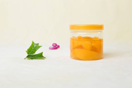 Still life of fruit in jar and plantの写真素材
