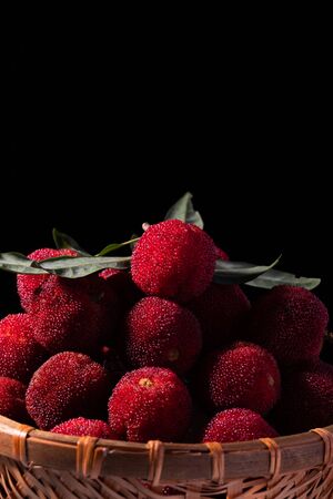 Chinese bayberries in bamboo basketの写真素材