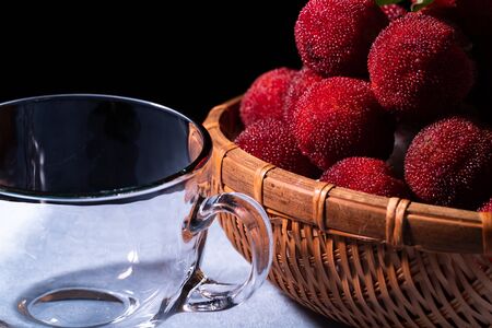 Chinese bayberries in bamboo basketの写真素材