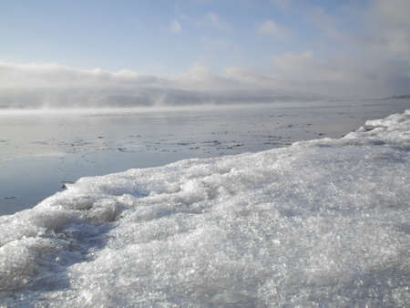 Thick fog over the river on a winter morningの写真素材