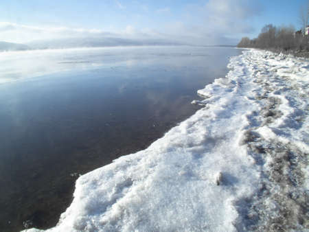 Thick fog over the river on a winter morningの写真素材