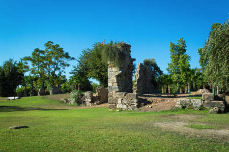 The ruins of an old building in the park on Otogar street. The ancient sights in Turkey. City landscape in the Side.の写真素材