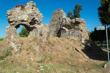 The walls of an ancient building in the city center of Side. The antique ruins near a Child park. Sights and tourist places in the Turkish city.のeditorial素材