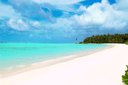 A deserted sandy beach on the Indian Ocean. Sunny day on the coast of the Maldives islandの写真素材