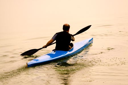 rower with canoe training in a lakeの写真素材
