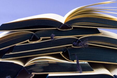 Old book collection with the front of its pages tinted of blueの写真素材