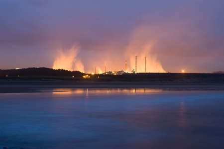 to get late stormy near the sea with industry to the bottomの写真素材