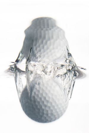 plunge in the water of a golf ballの写真素材