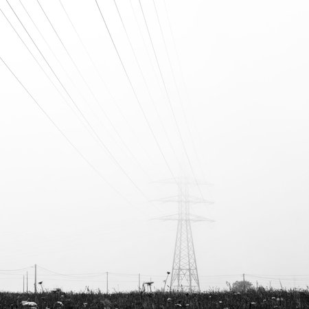 electrical tower of high voltage between light fog. Black and whiteの写真素材
