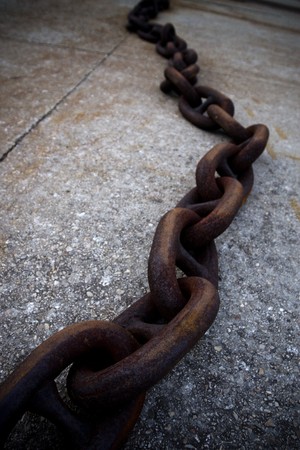 Heavy chain of steel oxidized by the passage of time. Both the composition and the accused support the sensation of oppressionの写真素材