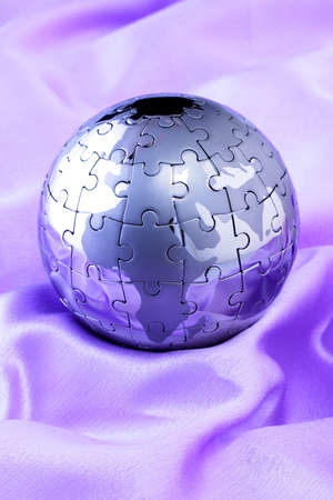 Metal puzzle globe isolated on white background の写真素材