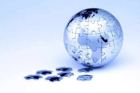 Metal puzzle globe isolated on white background の写真素材