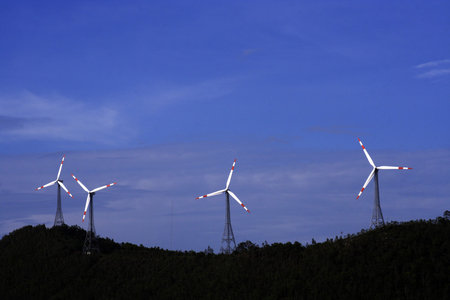 White wind turbines in the top of the mountain 