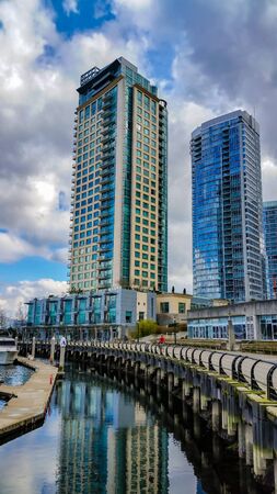 Reflective buildings along the shoreline of Coal Harbour, Vancouver, British Columbiaの写真素材