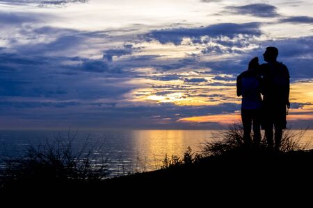 Romantic couple watching a sunset on the cliffs at Pelican Cove Park, Rancho Palos Verdes, Californiaの写真素材