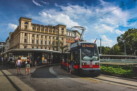 Passengers boarding light rail train at Schottentor Light Rail Station in Vienna, Austriaのeditorial素材