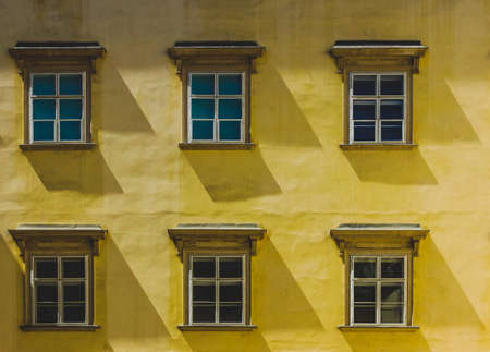 Close-up view of windows in an old, yellow building in Vienna, Austriaの写真素材