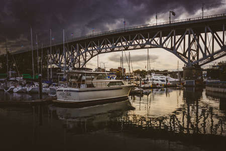 Boats docked in False Creek with Granville Bridge in the background at sunset, Vancouver, British Columbiaの写真素材