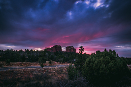Beautiful Cathedral Rock formation with dramatic pink and purple sky at sunset, Sedona, Arizonaの写真素材