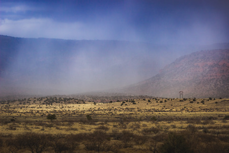 Dramatic sky over Verde Valley as a snowstorm rolls in, with mountains in the background, near Clarkdale, Arizonaの写真素材