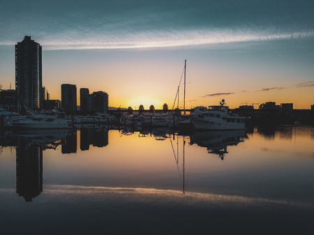 Cityscape from Quayside Marina taken at sunrise with reflections of buildings and boats in the calm water, Vancouver, British Columbiaの写真素材