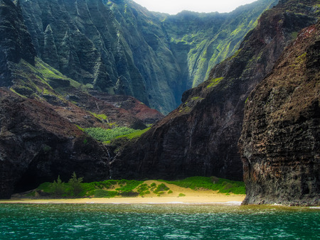 Stunning view of secluded Kalalau Beach and Kalalau Valley from a boat on a sunny day, Na Pali Coast, Kauai, Hawaiiの写真素材
