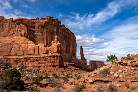 Scenic view of monolithic sandstone rock structures seen along the Park Avenue Trail with Tower of Babel in the distance, Arches National Park, Moab, Utahの写真素材