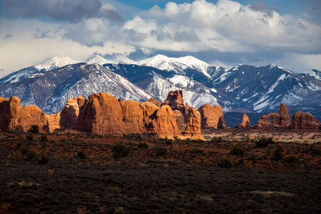 Colorful view of Parade of Elephants sandstone rock formations in the high desert with snowcapped La Sal Mountains in the background, Arches National Park, Moab, Utahの写真素材