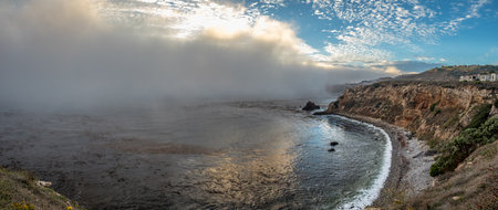 Experience the beauty of Rancho Palos Verdes as a marine layer blankets the coast, creating a mesmerizing cloudscape over rugged cliffs and hidden gems like Point Vicente Lighthouse and Pelican Cove.の写真素材