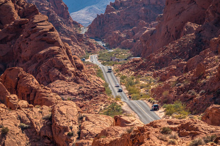 Mouse's Tank Road winds through the vibrant red sandstone formations of Valley of Fire State Park, Nevada.の写真素材