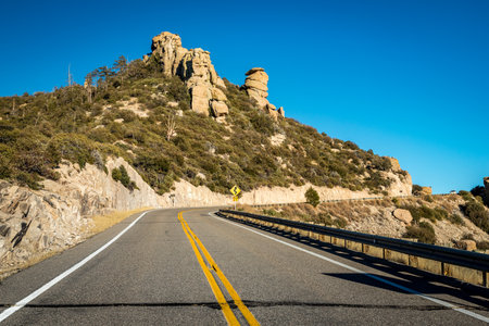 Enjoy the winding roads of Mount Lemmon Highway, surrounded by stunning desert landscapes and majestic mountains during a sunny day.の写真素材