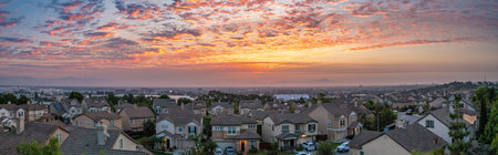 Vibrant sunrise casts a warm glow over Signal Hill, illuminating the tranquil urban skyline and inviting moments of peace and relaxation.の写真素材