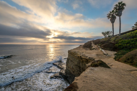 Relaxing evening on the cliffs of Point Loma, with gentle waves crashing against the rugged shore as...