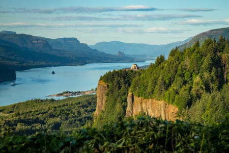 Breathtaking landscape of the Columbia River Gorge, featuring the stunning Vista House at Crown Point nestled among lush greenery.の写真素材