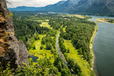 View from above at Beacon Rock State Park reveals the winding Columbia River and lush greenery,...