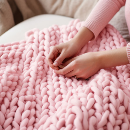 Women's hands knit a warm blanket. Handmade. Textured blanket in a large knit with chunky thread, comfortable soft woven materialの素材