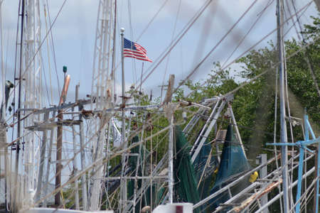 Shrimp boat masts with American flagの写真素材