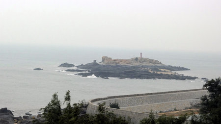 Rock island with lighthouseの写真素材