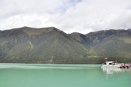 Boat in a lake by the mountainsの写真素材