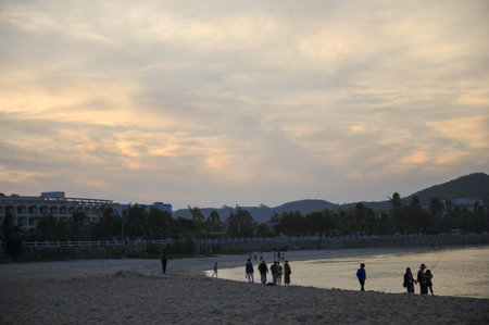 People by the beach in the eveningの写真素材