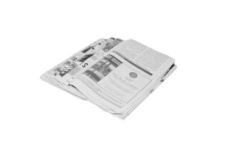 Newspaper folded and stacked black and white background blurredの写真素材