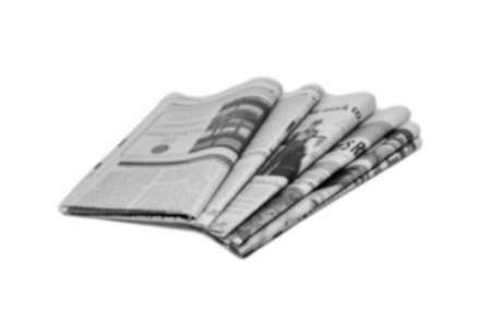 Newspaper folded and stacked black and white background blurredの写真素材