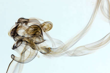 Incense smoke spiral colors on white backgroundの写真素材