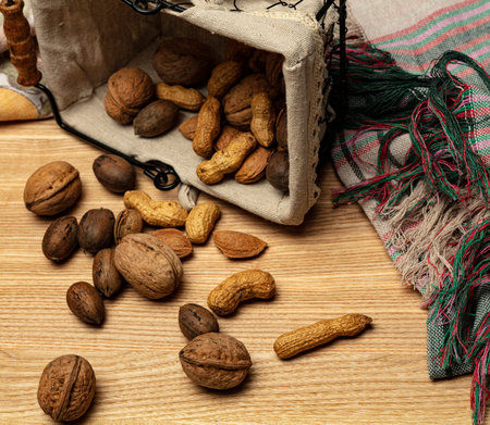 Walnut almonds peanuts over wooden background.