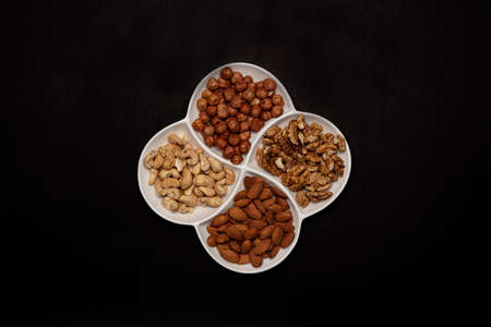 Set of various nuts in white plate.の写真素材