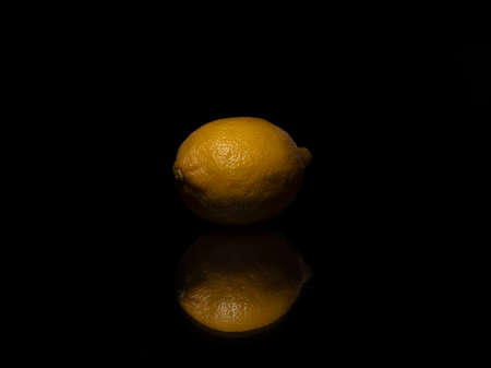 Single lemon on black backgroundの写真素材