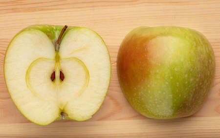 Green sliced apple on a wooden backgroundの写真素材