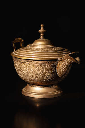 Silver metal old teapot isolated on blackの写真素材