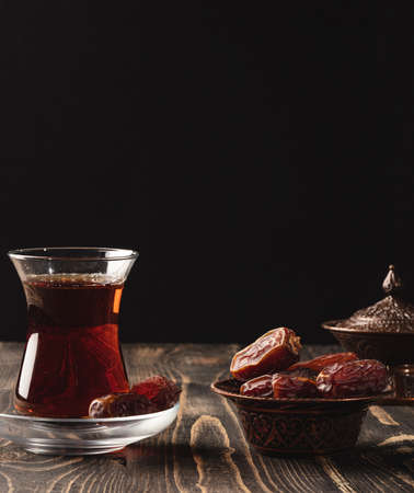 Ramadan concept with a cup of tea and datesの写真素材